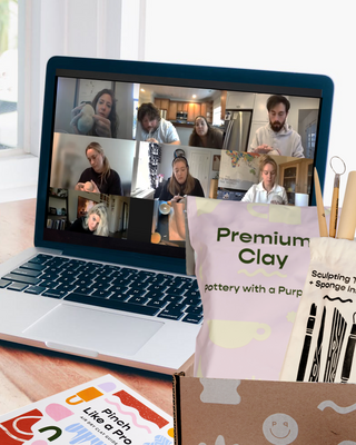 Laptop displaying a video call with people participating virtually in a pottery workshop, next to a box labeled 'Premium Clay' and other items.